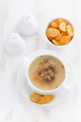delicious mushroom cream soup with croutons on white table