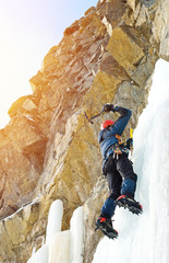 Ice climbing in winter mountains