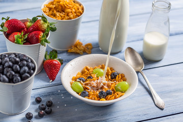 Cornflakes with fruits flooded with milk