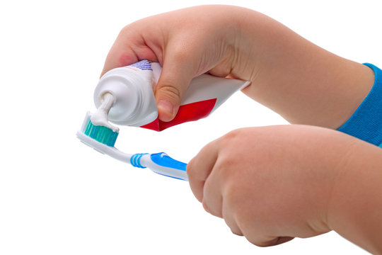 Child  squeezes the toothpaste
