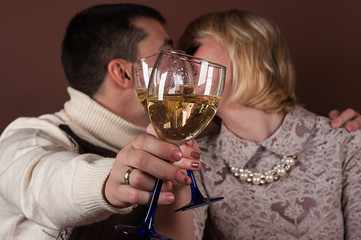 young couple kissing holding champagne glasses