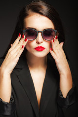 Glamour woman with sunglasses, red lips and nails