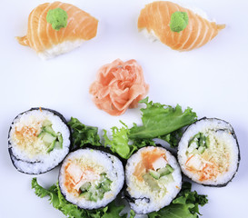 Sushi maki set and sakura branch. Isolated on white background
