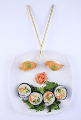 Sushi maki set and sakura branch. Isolated on white background