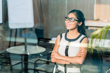 Indonesian business woman at office window