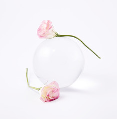 Two rosebud on a glass bowl.