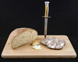 Retro pork brawn, rye bread and onion menu with vintage dagger