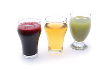 Fresh fruit and vegetable juices on white background