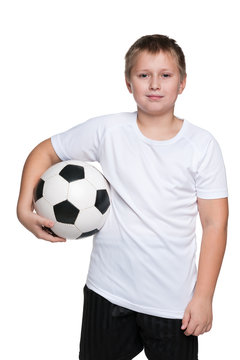 Confident young boy with soccer ball