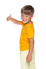 Happy little boy holds his thumb up