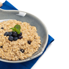 Porridge Oatmeal with fresh blueberries. Selective focus.