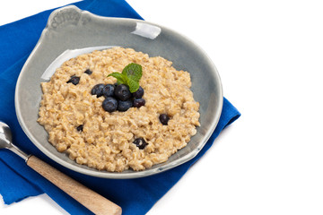 Porridge Oatmeal with fresh blueberries. Selective focus.