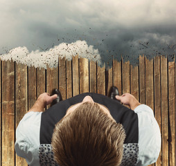 Man standing on the edge in clouds