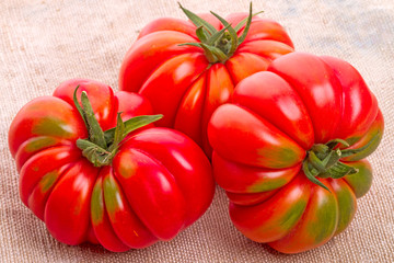 Three tomatoes on burlap