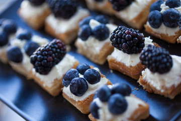 Plate of small waffles with cream cheese
