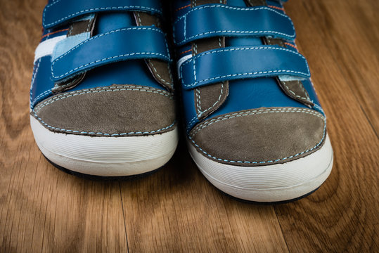 blue sneakers on wooden background