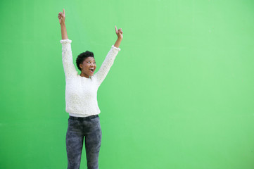 Happy african american woman cheering with arms raised