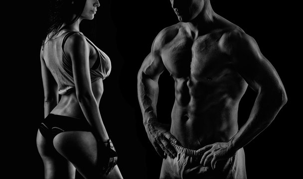 Bodybuilding. Strong man and a woman posing on a black backgroun