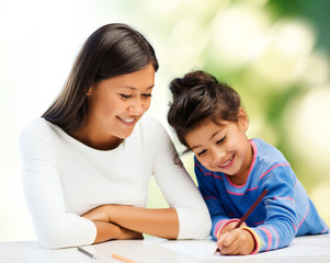 Fototapeta premium happy mother and daughter drawing with pencils