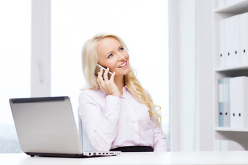 smiling businesswoman calling on smartphone
