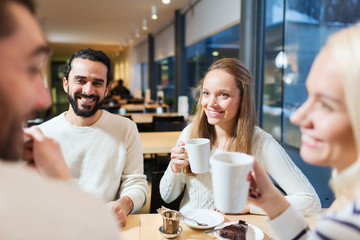 happy friends meeting and drinking tea or coffee