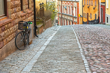 Bike parked on old picturesque street in the city.
