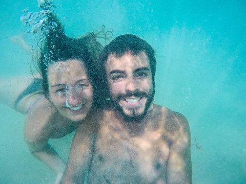 Beautiful Couple Swimming underwater. Selfie at the Caribbean Me