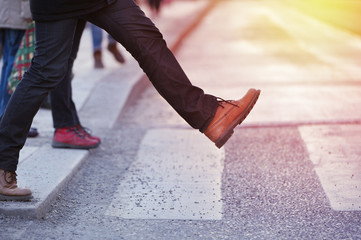 Man taking the step (onto zebra crossing)