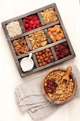 granola muesli, nuts, honey, dried berries and milk. Top view.