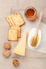 Fototapeta na wymiar Parmesan cheese, honey, cookies and nuts