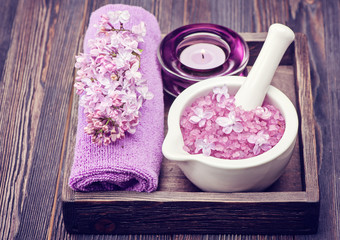 Spa sea salt in mortar and lilac flowers. Spa.