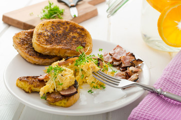 Scrambled eggs with French toast topped with watercress