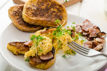Scrambled eggs with French toast topped with watercress
