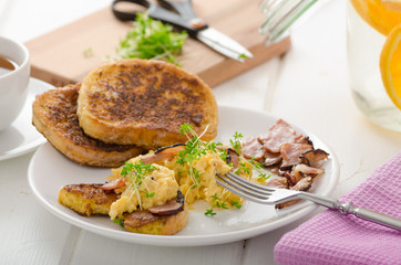Scrambled eggs with French toast topped with watercress