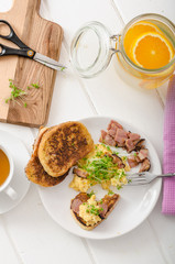 Scrambled eggs with French toast topped with watercress