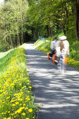 People cycling through countryside