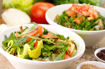 Plates of traditional Arabic salad fattouch and tabbouleh