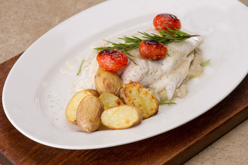Fish dish - fish fillet in sauce and vegetables