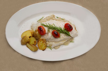 Fish dish - fish fillet in sauce and vegetables