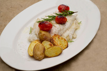 Fish dish - fish fillet in sauce and vegetables