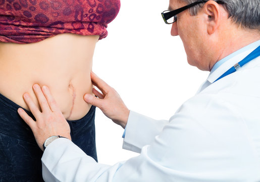 Doctor checking pregnant belly stomach after birth operation