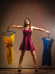  Addicted to shopping woman, marionette on string.