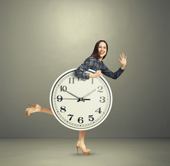 laughing woman holding big white clock