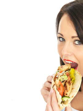 Young Woman Eating Chicken Kebab With Salad