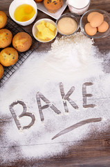 The word bake written in flour baking making cakes with ingredients photo