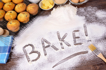 The word bake written in flour baking making cakes with ingredients photo