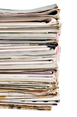 Stack of old newspapers and magazines tall isolated on white photo