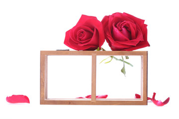 wood shelf decorated with red rose flowers isolated