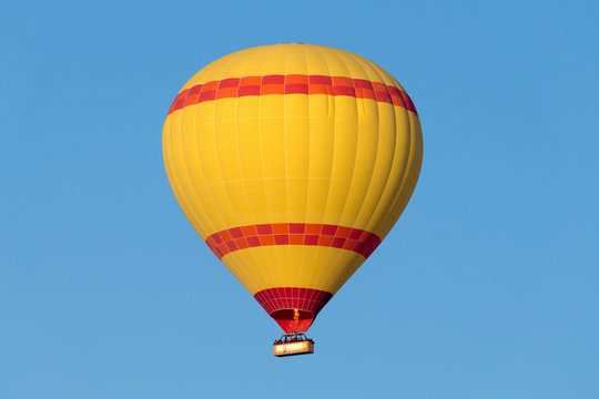 A hot air balloon flying on a clear sky day.