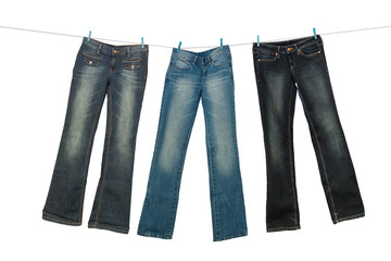 Jeans on clothesline on a white background